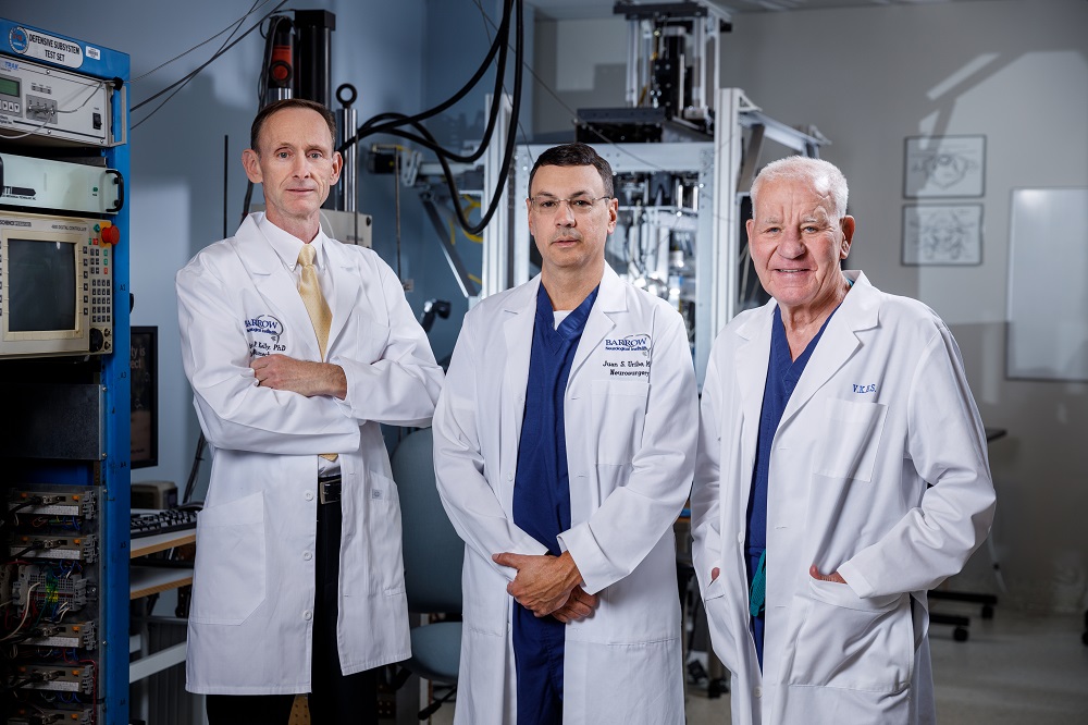 brian kelly, juan uribe, and volker sonntag stand in the sonntag spine center