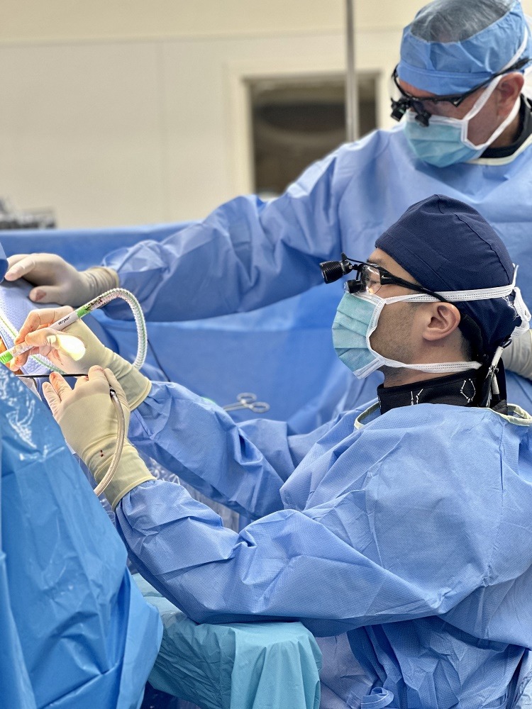 spinal neurosurgeon bryan lee performs spine surgery in an operating room
