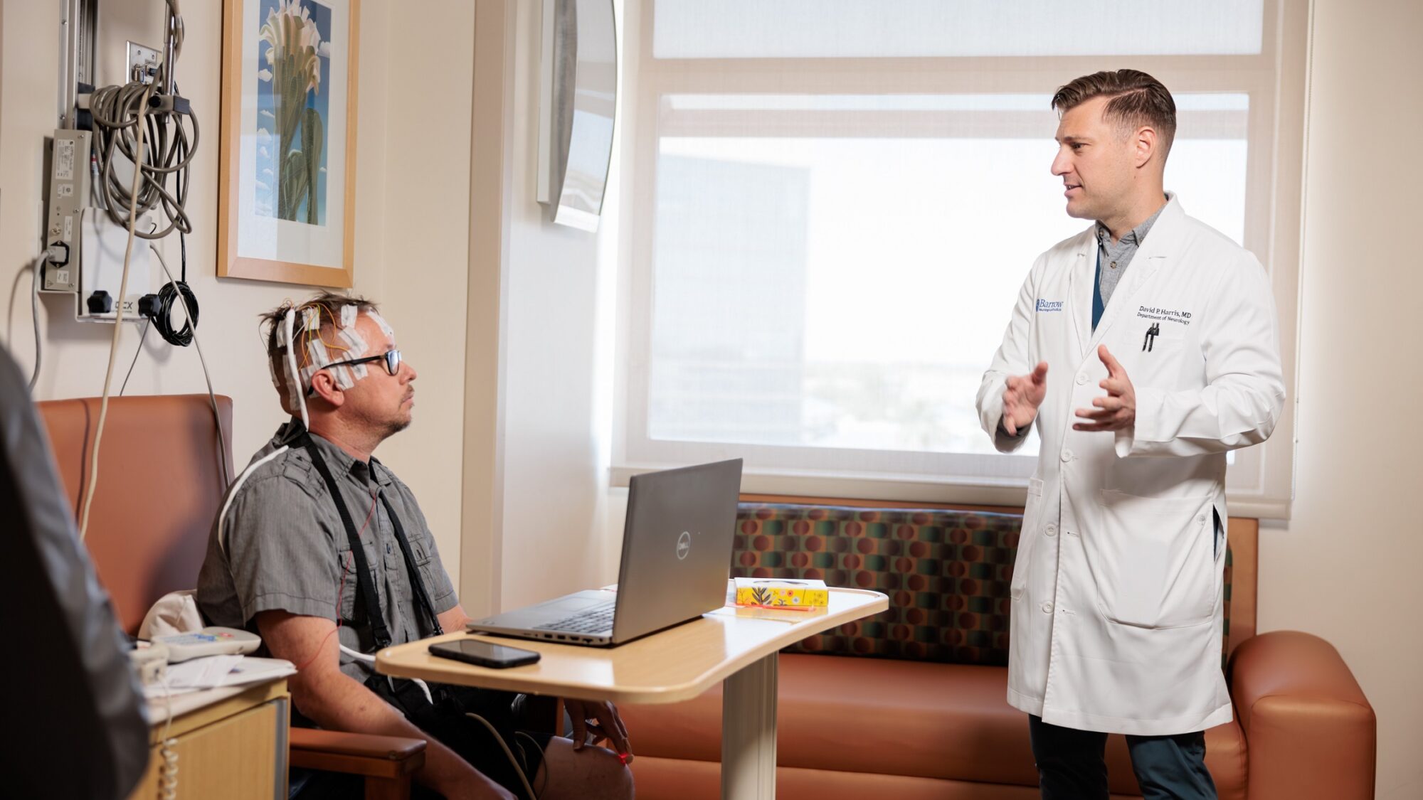 neurologist david harris talks to a patient in the epilepsy monitoring unit