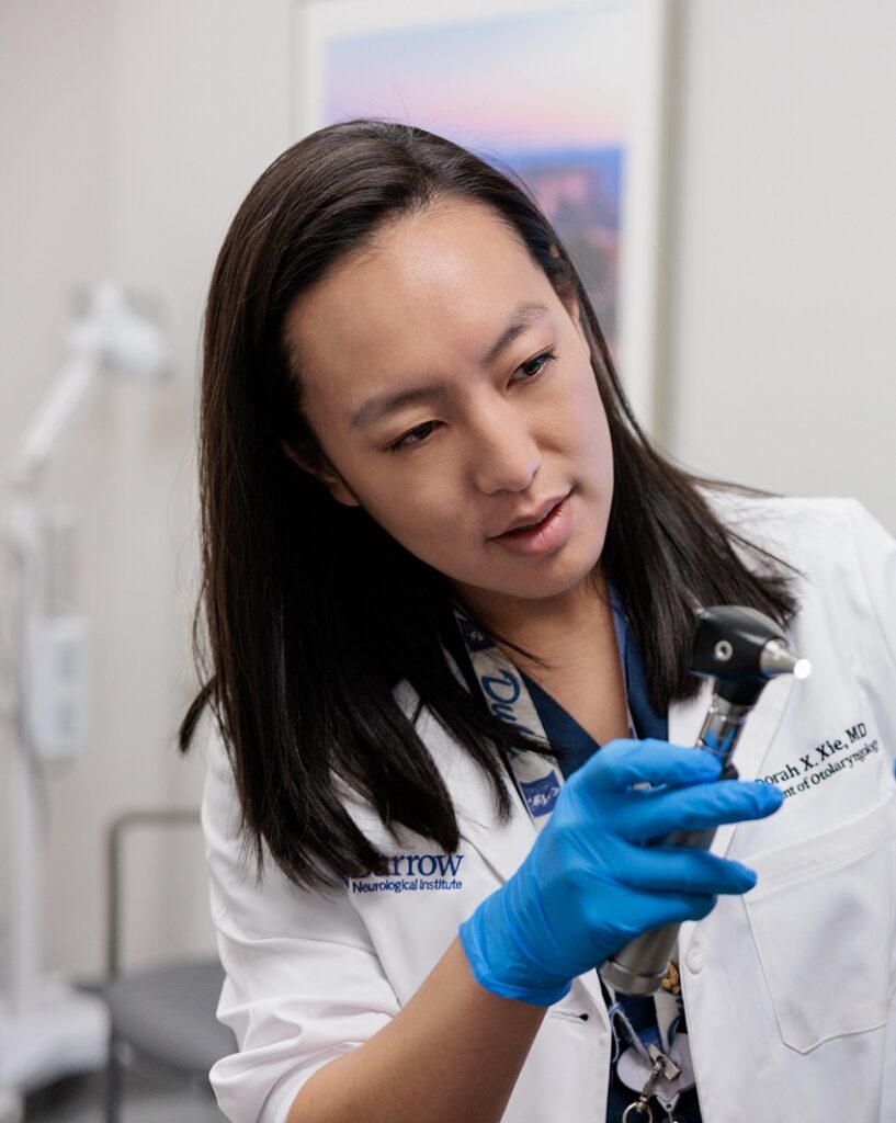 head and neck cancer surgeon deborah xie consults with a patient in an exam room
