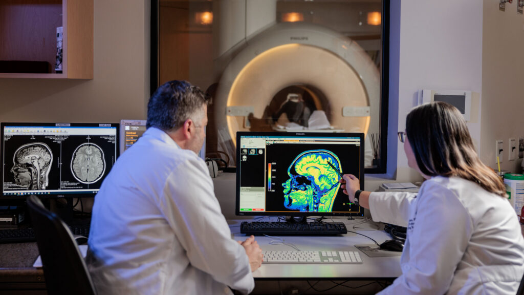Dr. Richard Dortch and Dr. Ashley Stokes review MRI imaging for research in the Neuroimaging Innovation Center.