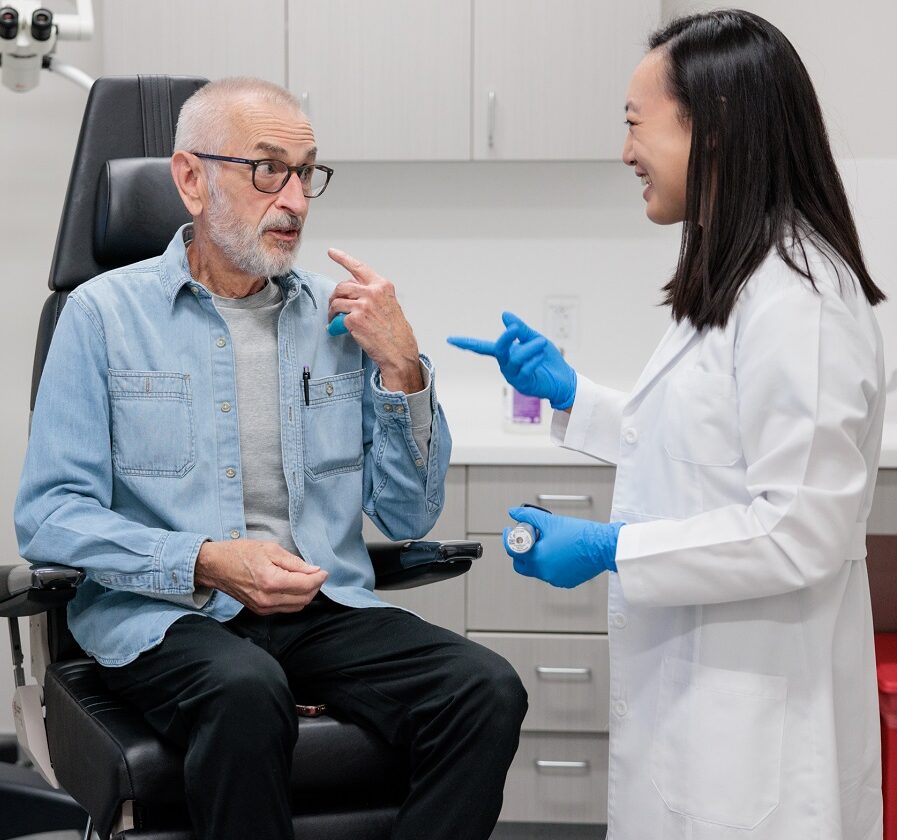 head and neck cancer surgeon deborah xie consults with a patient in an exam room