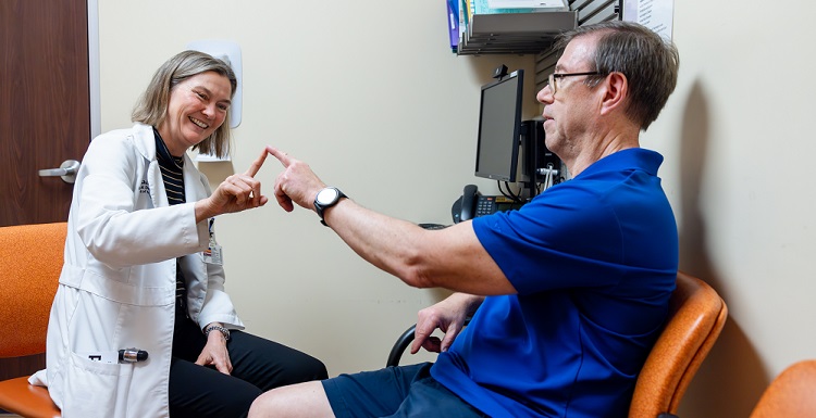 holly shill examines a movement disorders patient