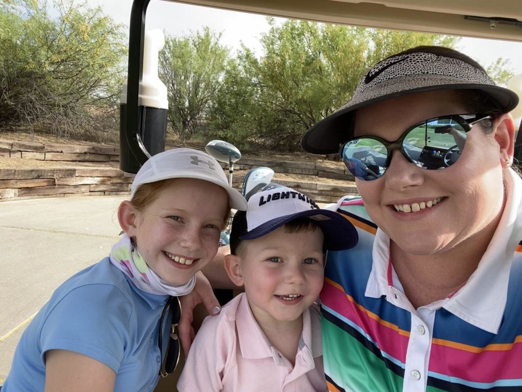 Photo of Hope Terry with two of her kids in a golf cart