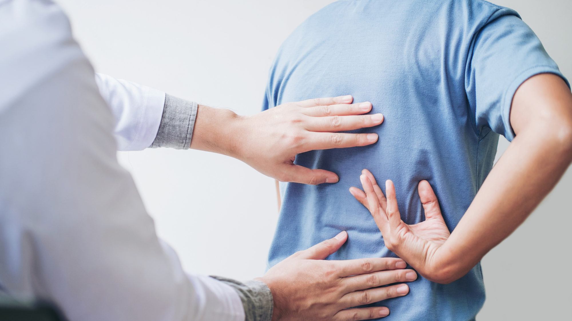 doctor examining patient's back