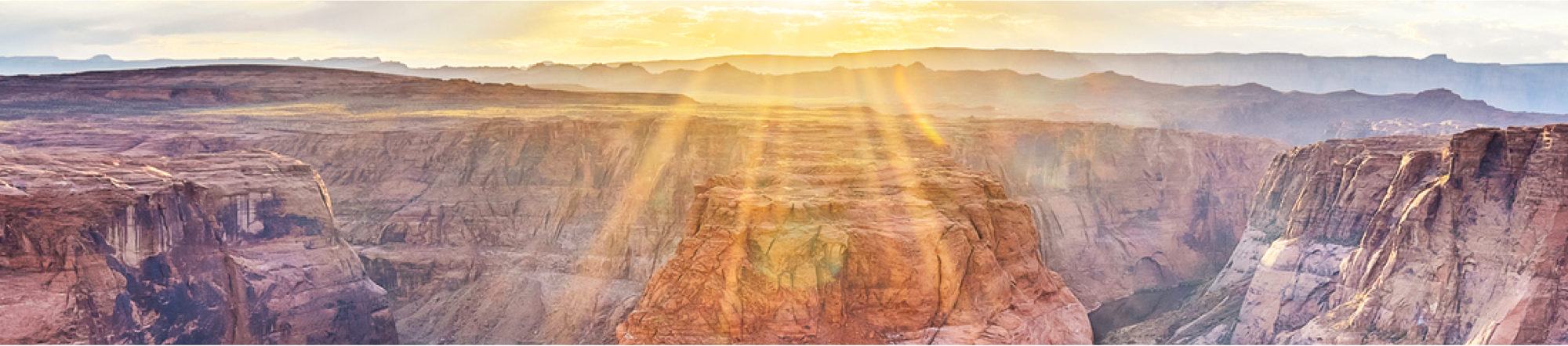 sun shining down on a canyon