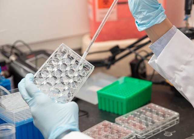 researcher using droplet to put liquid in test tubes