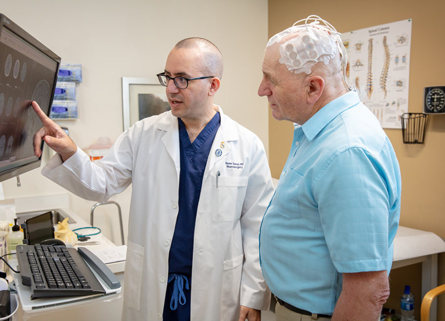 A photo of Dr. Nader Sanai with a patient