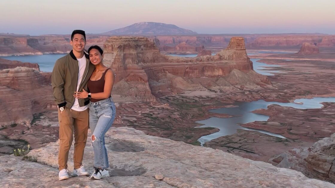 kyle kaneko posing on a cliff overlooking of lake powell