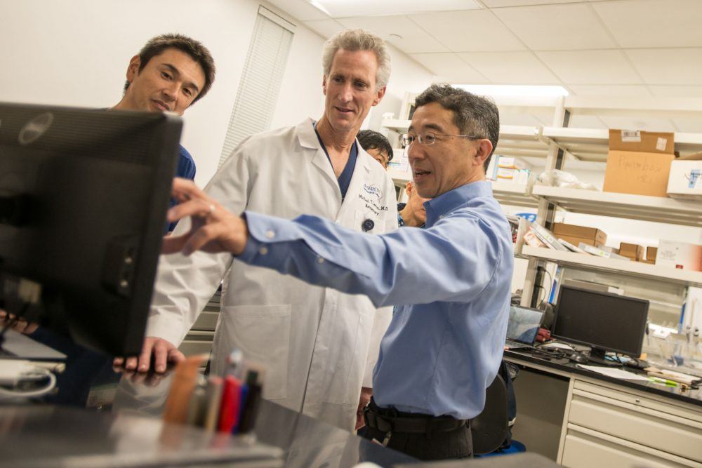 Dr. Michael Lawton and Dr. Tomoki Hashimoto in a laboratory