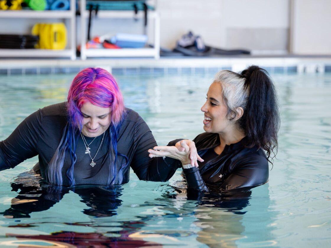 Barrow Neuro-Rehab Patient completes exercises in a pool with their therapist.