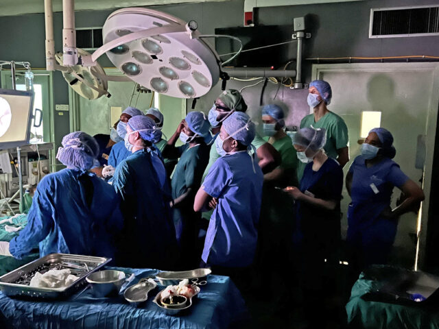 Trainees and surgical staff gather around Barrow neuroanesthesiologist Dr. Brian Wilhelmi in the operating room at Kilimanjaro Christian Medical Centre.
