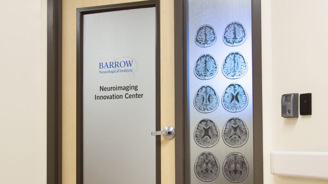 A door with frosted glass reads "BArrow Neuorimaging Innovation Center" and features images of the human brain.