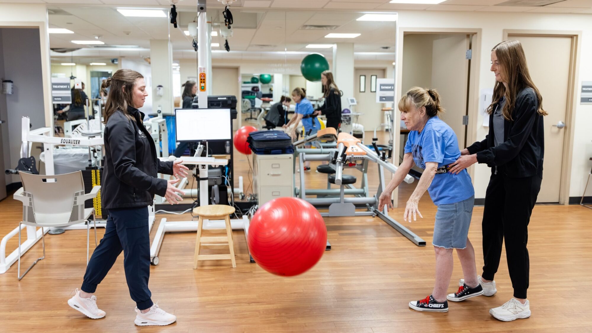 Barrow Neuro-Rehab patient exercises coordination skills by bouncing a ball back and forth with their therapist.