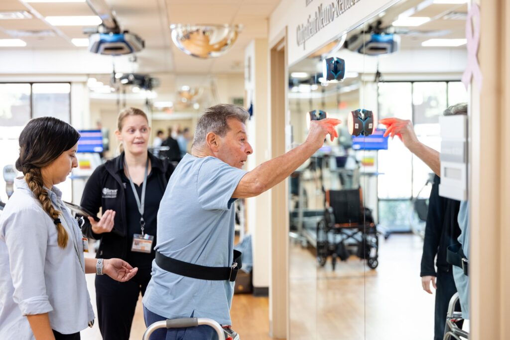 Barrow Neuro-Rehab patient touching light up buttons for coordination and neuro-plasticity.