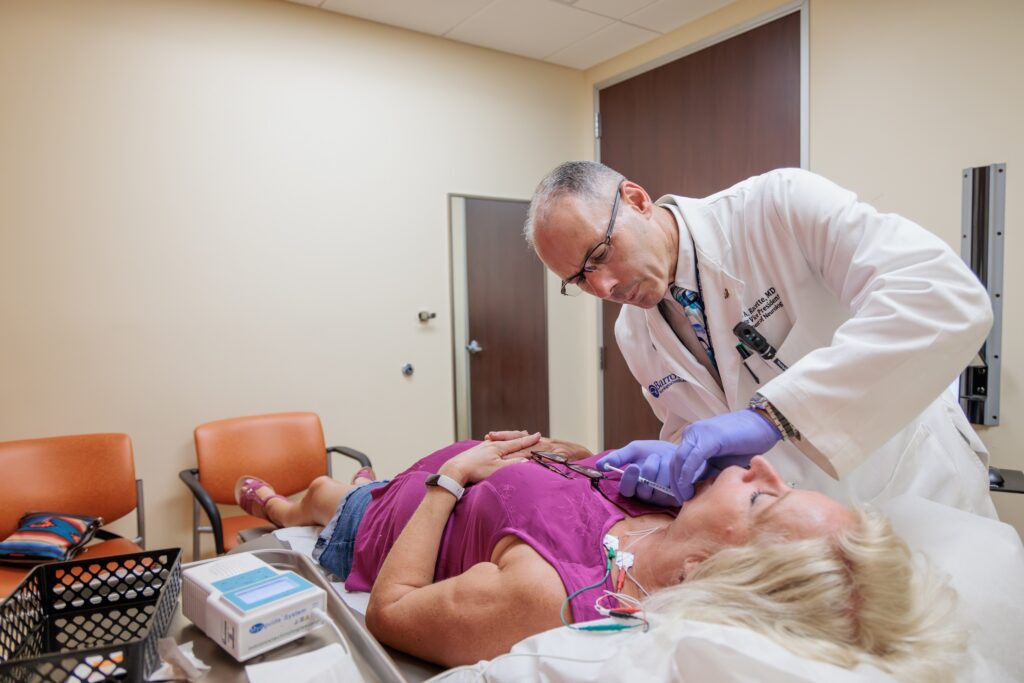 neurologist brad racette administers botox to a patient with parkinson's disease