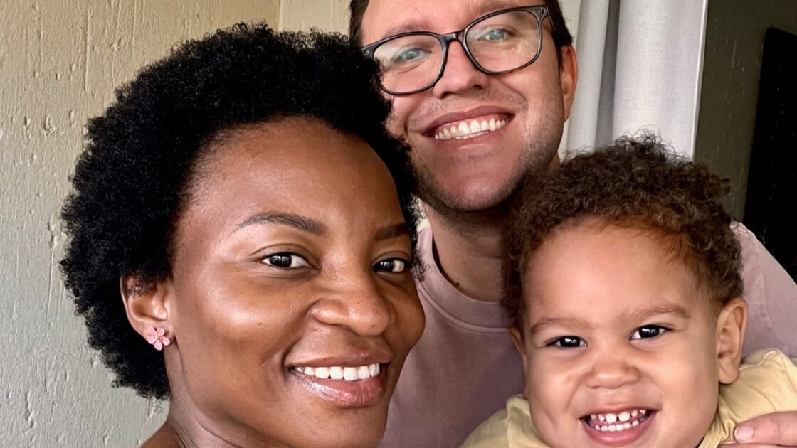 ryan wagner posing with his wife and child