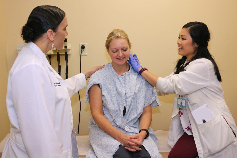 Dr. Courtney Schusse treating patient with resident