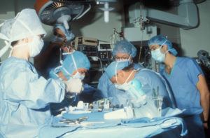 Dr. Volker Sonntag, Dr. Robert Spetzler, and Dr. Hal Rekate in the operating room performing surgery on Timothy Mathias.