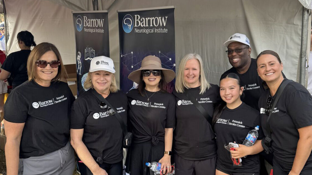 Barrow team at Phoenix Heart Walk. They are under a pop-up with Barrow-branded banners behind them and are all wearing Barrow-branded T-shirts.