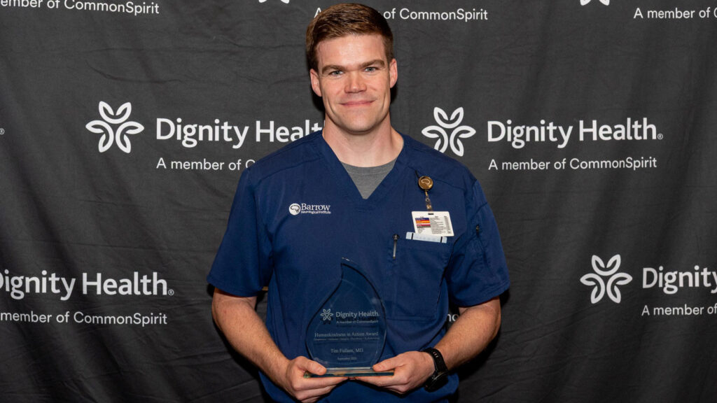 Dr. Timothy Fullam holding his award
