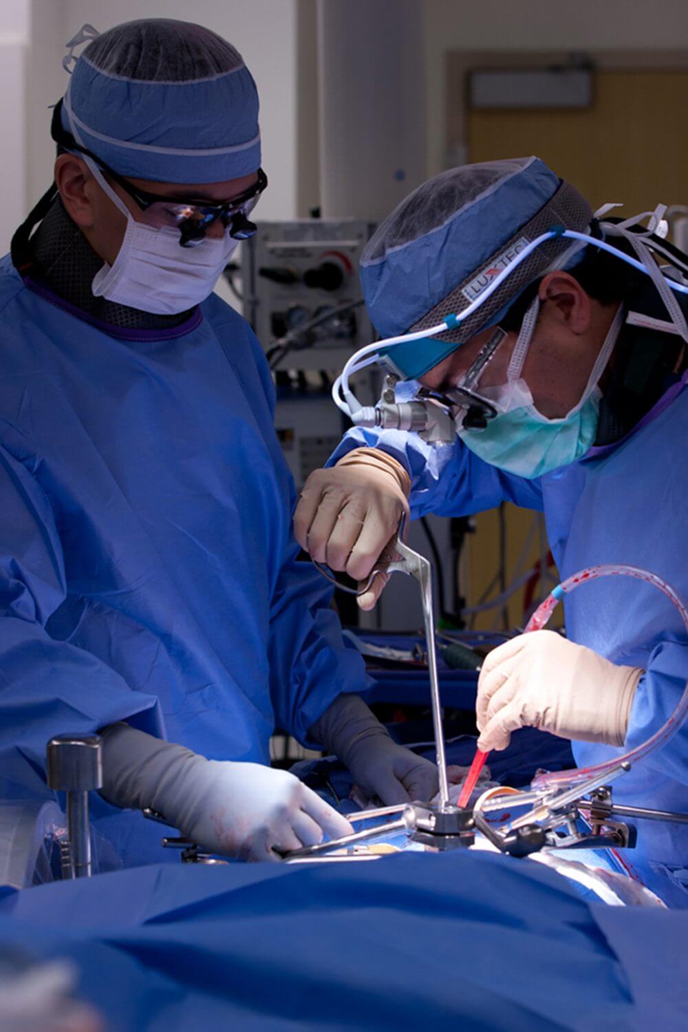 A photo of two doctors performing neurosurgery