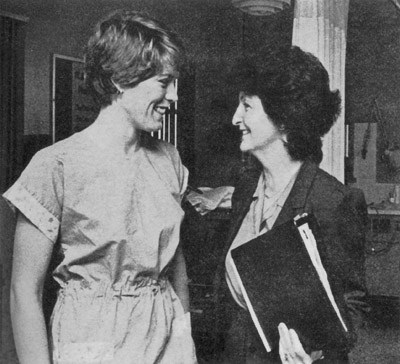 A black-and-white photo of Virginia Prendergast with social worker Marie Leyba. The two are looking at each other and smiling.