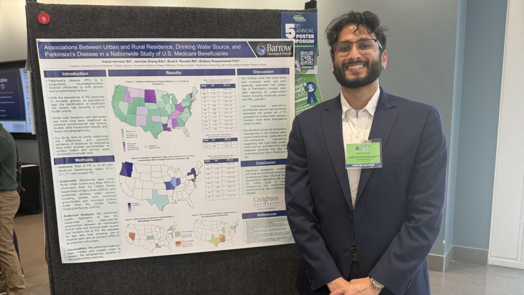 Creighton medical student Visha Harnoor stands next to his research poster at the Arizona Medical Association Annual Meeting